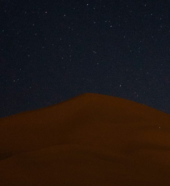 Cielo nocturno en Merzouga con la Vía Láctea y estrellas sobre las dunas del Sahara